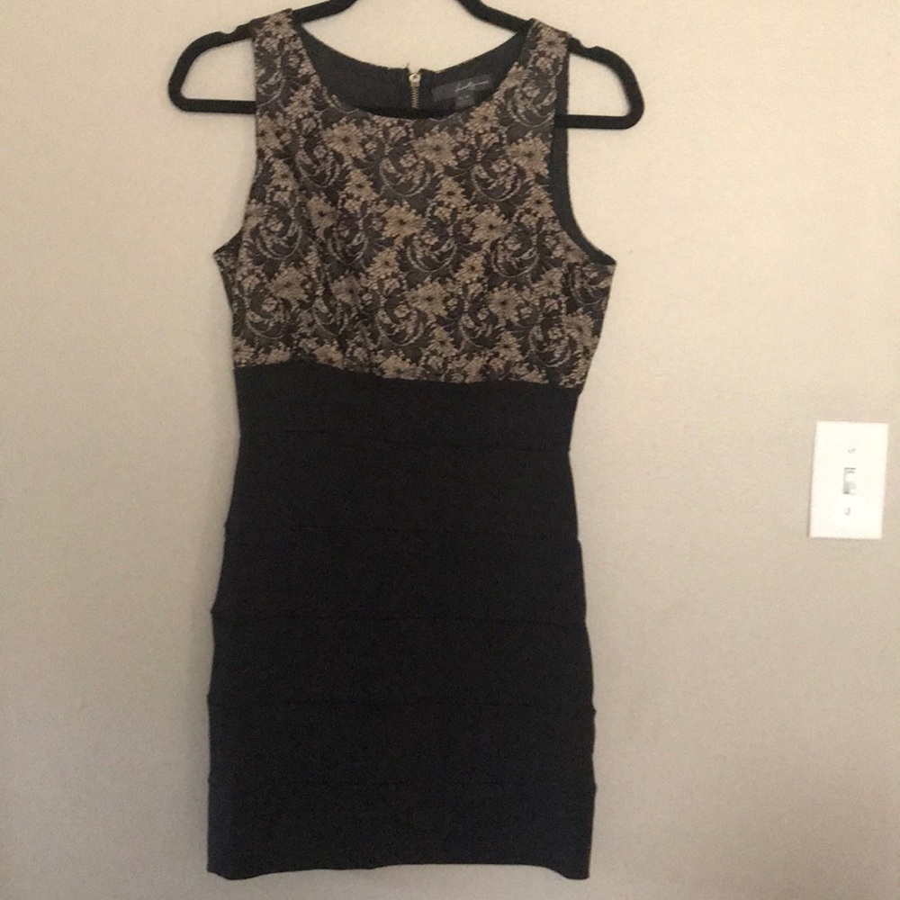 Little black dress with gold zipper on back.